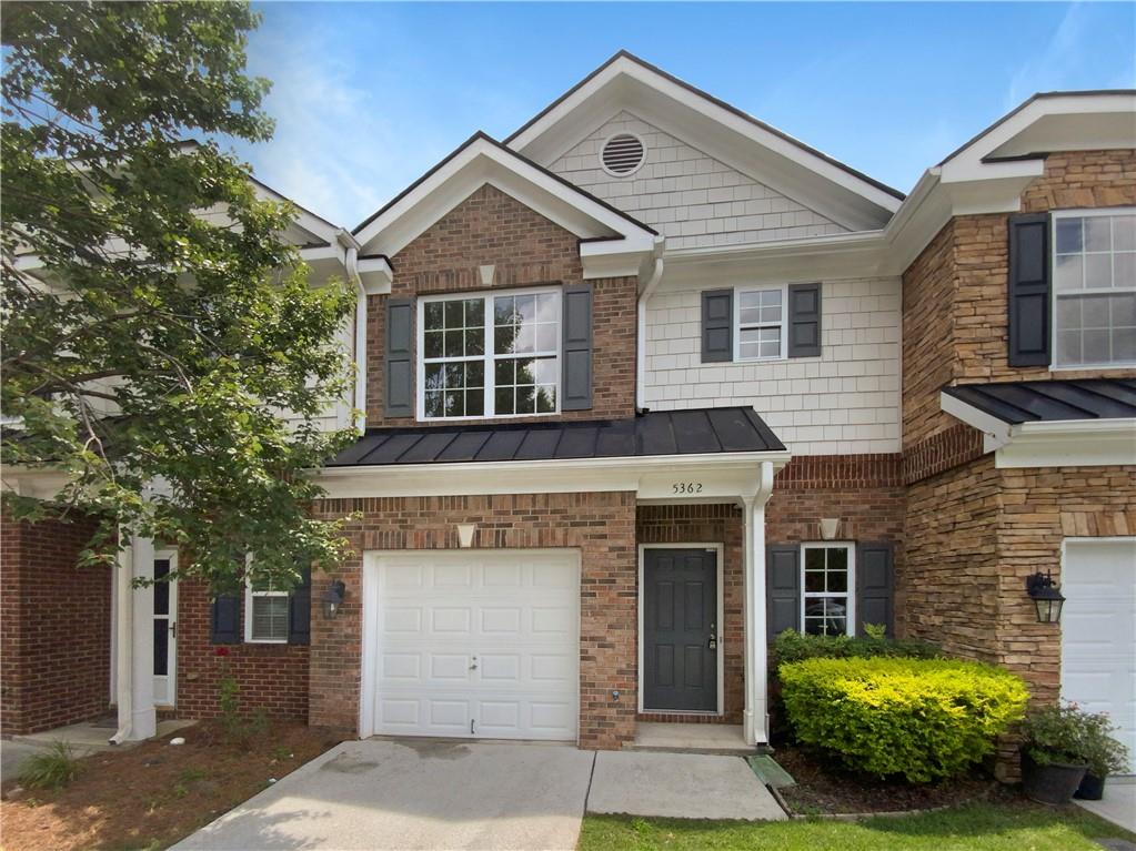 5362 Langston Road Norcross, GA 30071 - Photo 1 of 1 a front view of a house with a garden