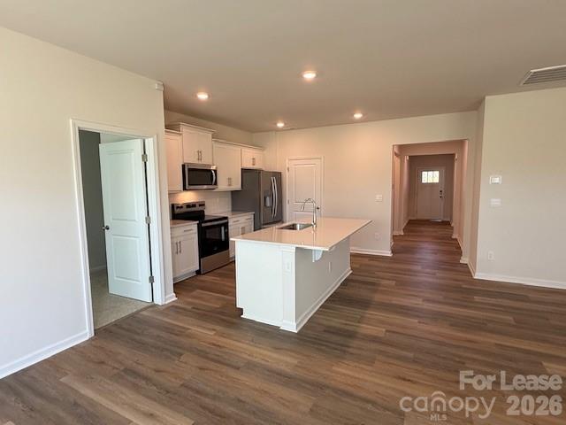 2315 Riggs Road Sherrills Ford, NC 28673 - Photo 8 of 17 a large kitchen with kitchen island a sink dishwasher a refrigerator and a stove with wooden floor