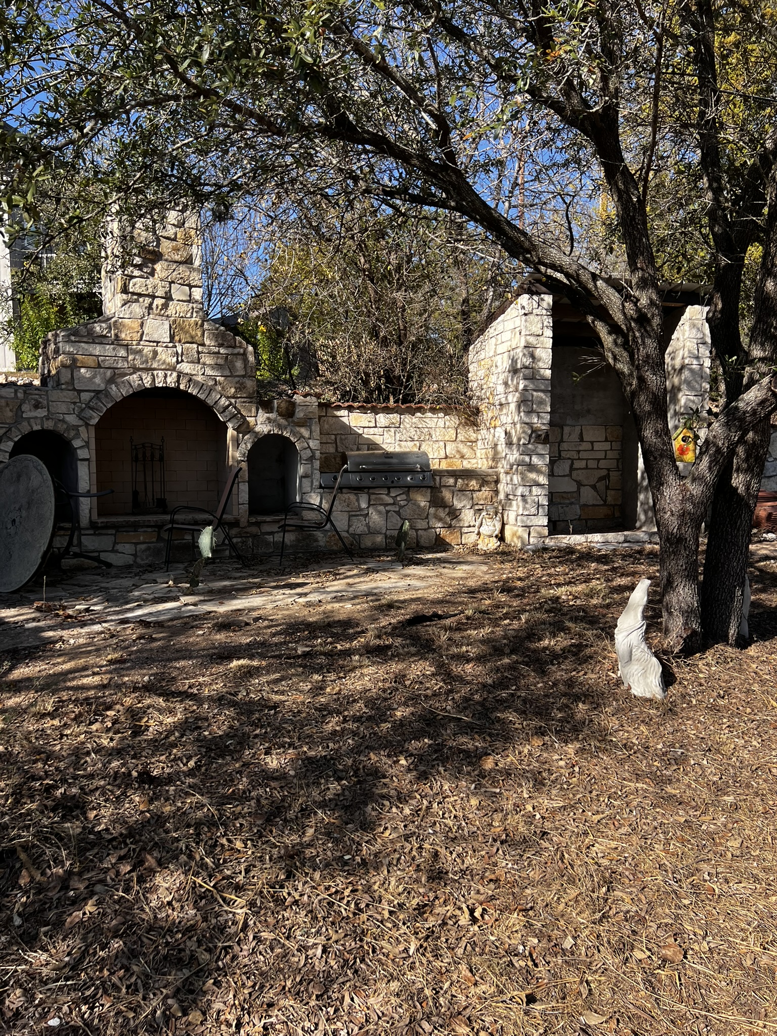 26809 Blue Cove Road Marble Falls, TX 78654 - Photo 20 of 20 View of yard with an outdoor stone fireplace