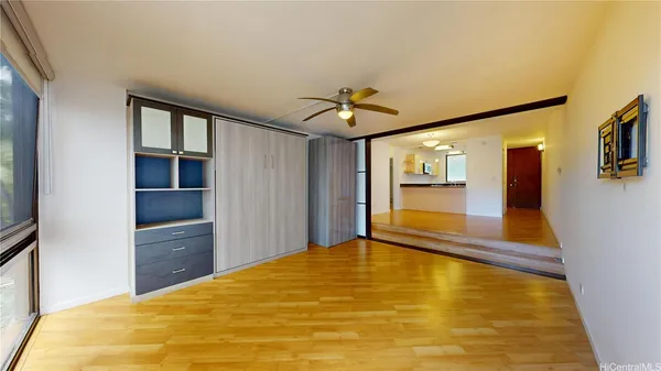 a view of an empty room with a fireplace and a window