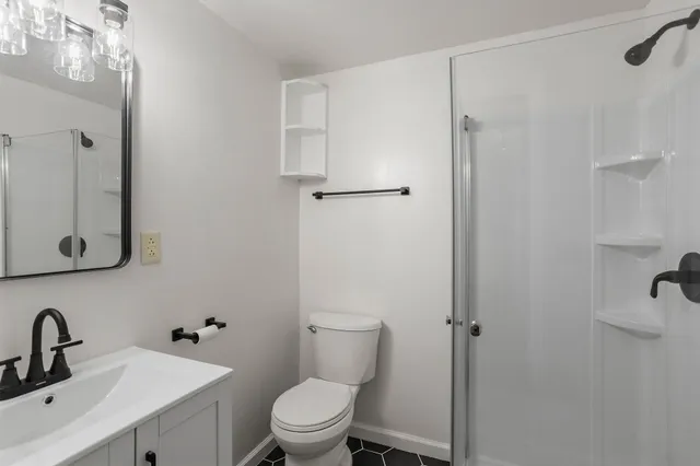 a bathroom with a toilet sink and shower