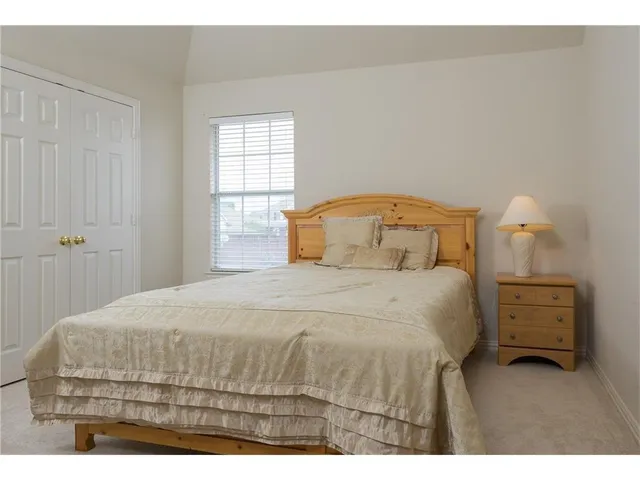 a bedroom with a bed and window