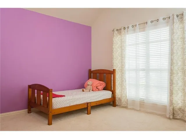 a bedroom with furniture and a window