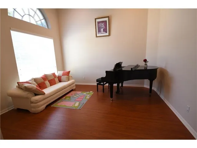 a living room with furniture and a coffee table with wooden floor