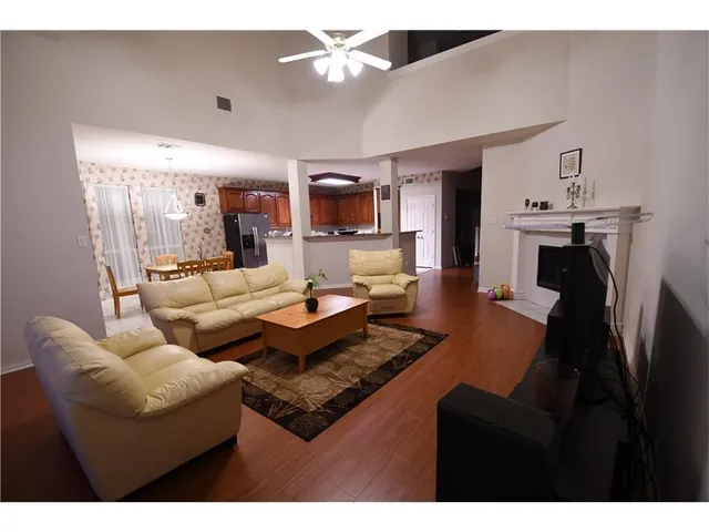 a living room with furniture a fireplace and a flat screen tv
