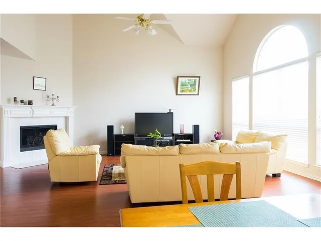 a living room with a flat screen tv and a fireplace