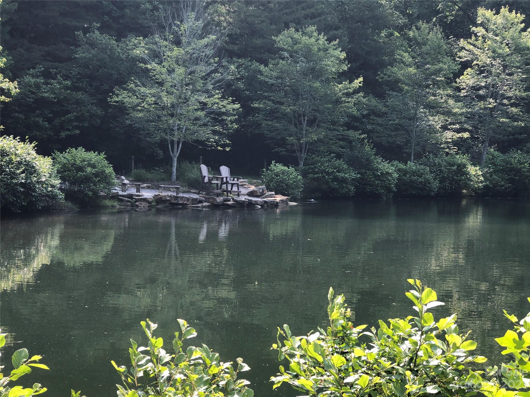 Tbd Deer Antler Road, Unit 84 Purlear, NC 28665 - Photo 27 of 36 a view of a lake with a house