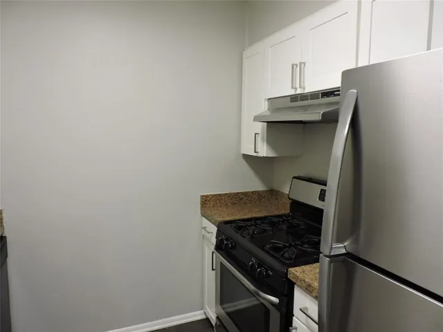 a kitchen with stainless steel appliances a refrigerator and a stove