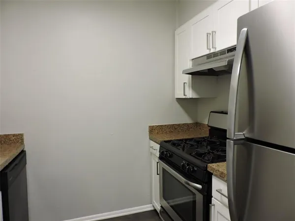 a kitchen with a stove and a refrigerator