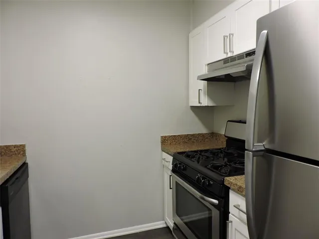 a kitchen with a stove and a refrigerator