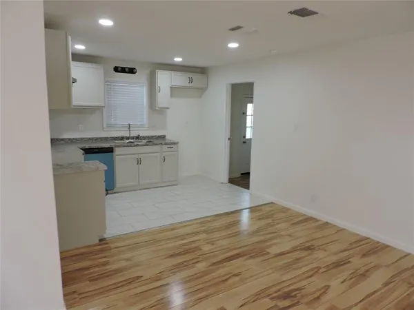 a large kitchen with granite countertop a stove and a sink