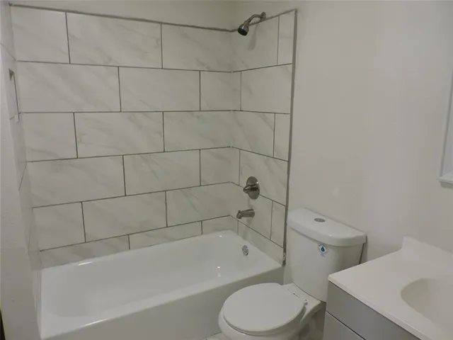 a bathroom with a toilet and bathtub