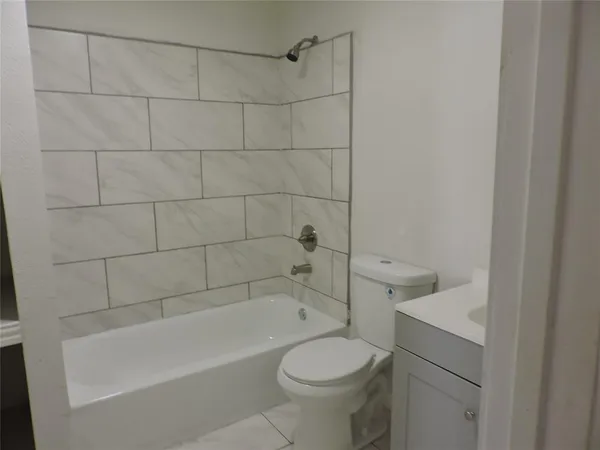 a bathroom with a sink a toilet and bathtub