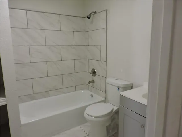 a bathroom with a sink a toilet and bathtub