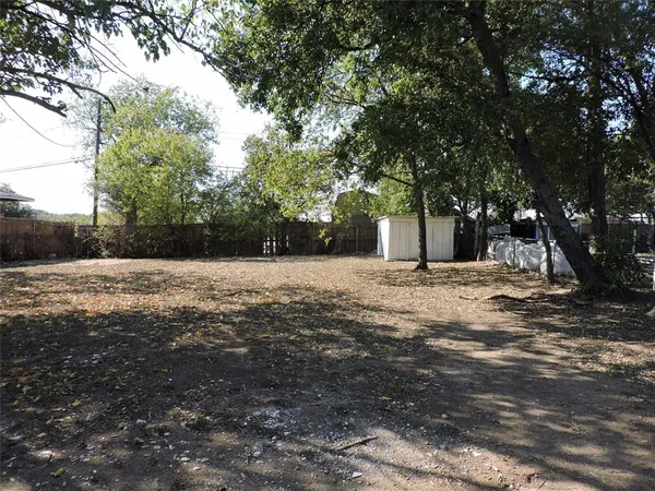 a view of backyard with large trees