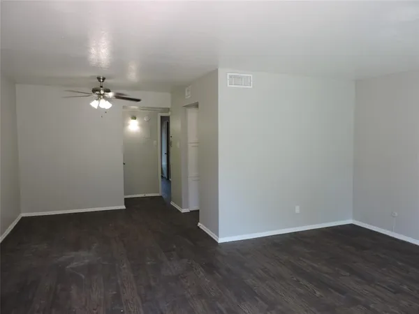 a view of an empty room and wooden floor