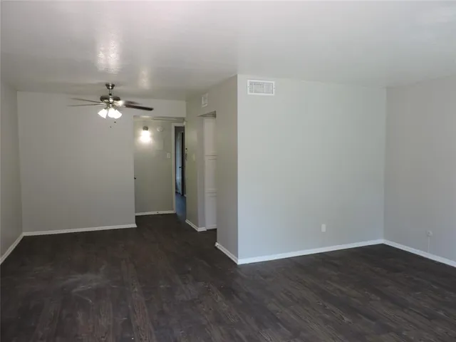 a view of an empty room and wooden floor