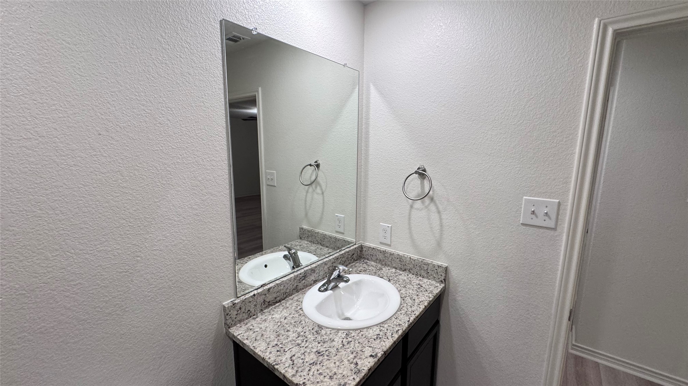 14421 Prairie Sod Lane Elgin, TX 78621 - Photo 7 of 10 A well-appointed bath features a sleek vanity and convenient mirror.
