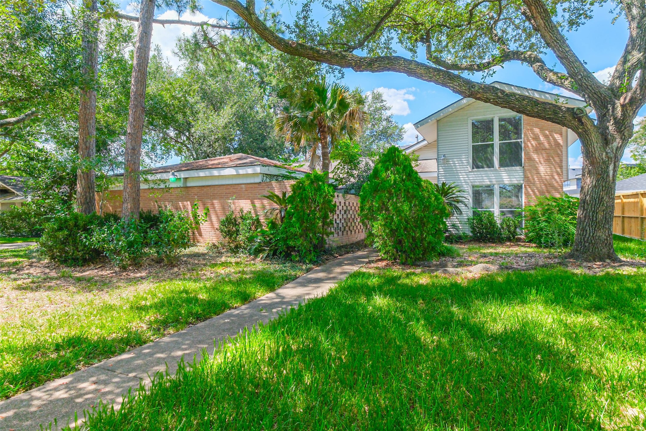 5218 Contour Place Houston, TX 77096 - Photo 1 of 22 a front view of a house with a yard