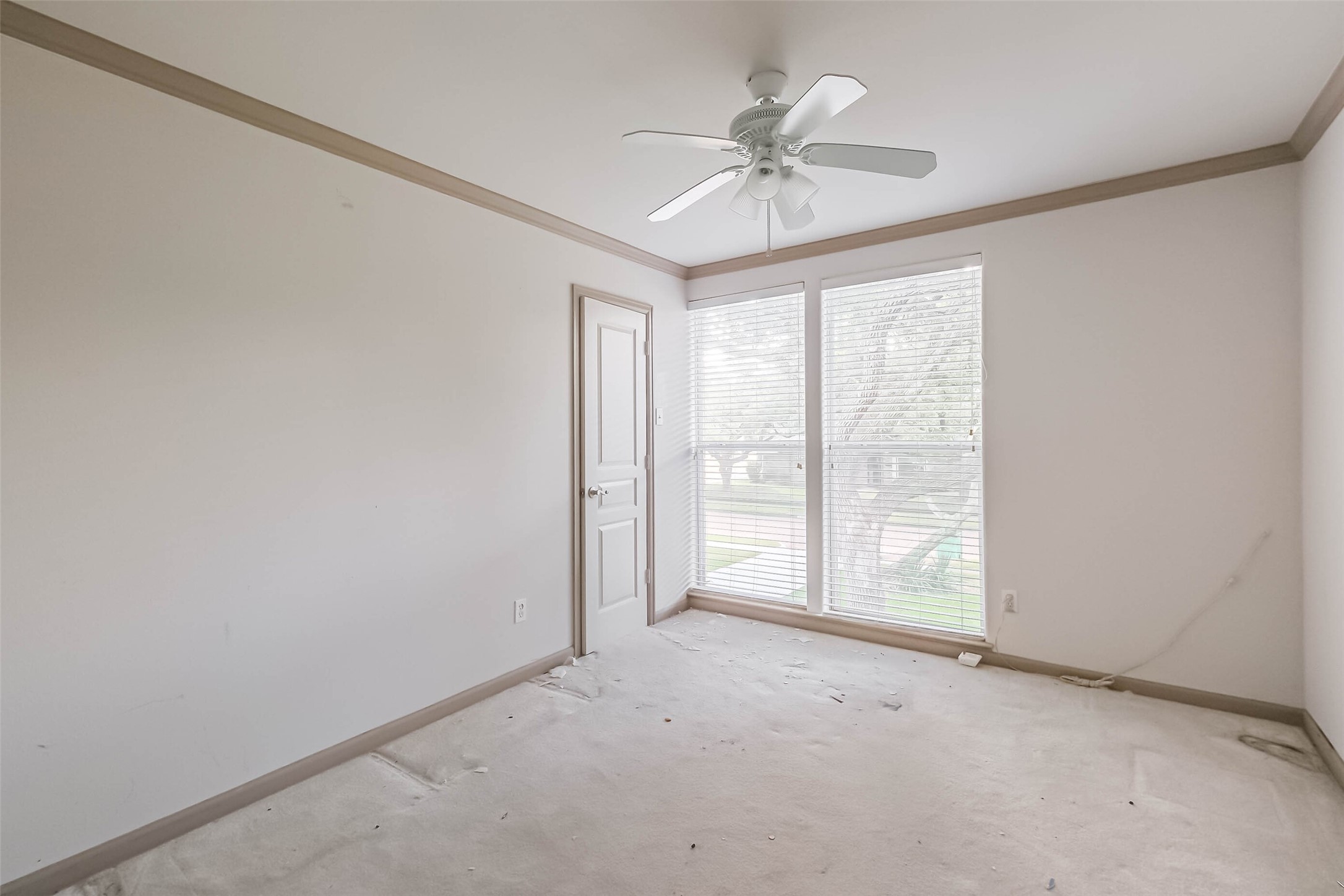 5218 Contour Place Houston, TX 77096 - Photo 18 of 22 an empty room with windows and chandelier fan