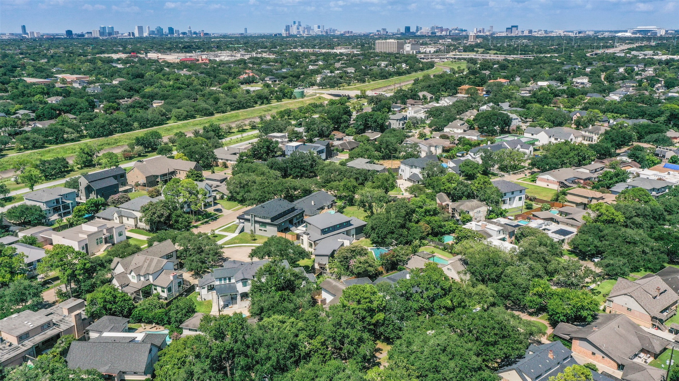 5218 Contour Place Houston, TX 77096 - Photo 3 of 22 an aerial view of a city with lots of residential buildings and mountain view in back