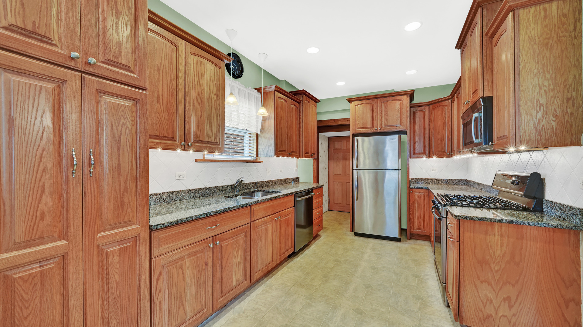 3130 Clinton Avenue Berwyn, IL 60402 - Photo 12 of 30 a kitchen with stainless steel appliances granite countertop a refrigerator a stove and a sink
