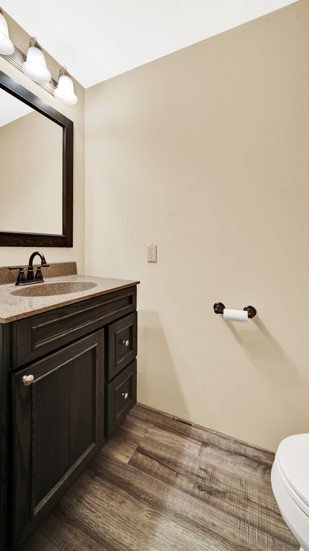 3130 Clinton Avenue Berwyn, IL 60402 - Photo 13 of 30 a bathroom with a sink a toilet and mirror