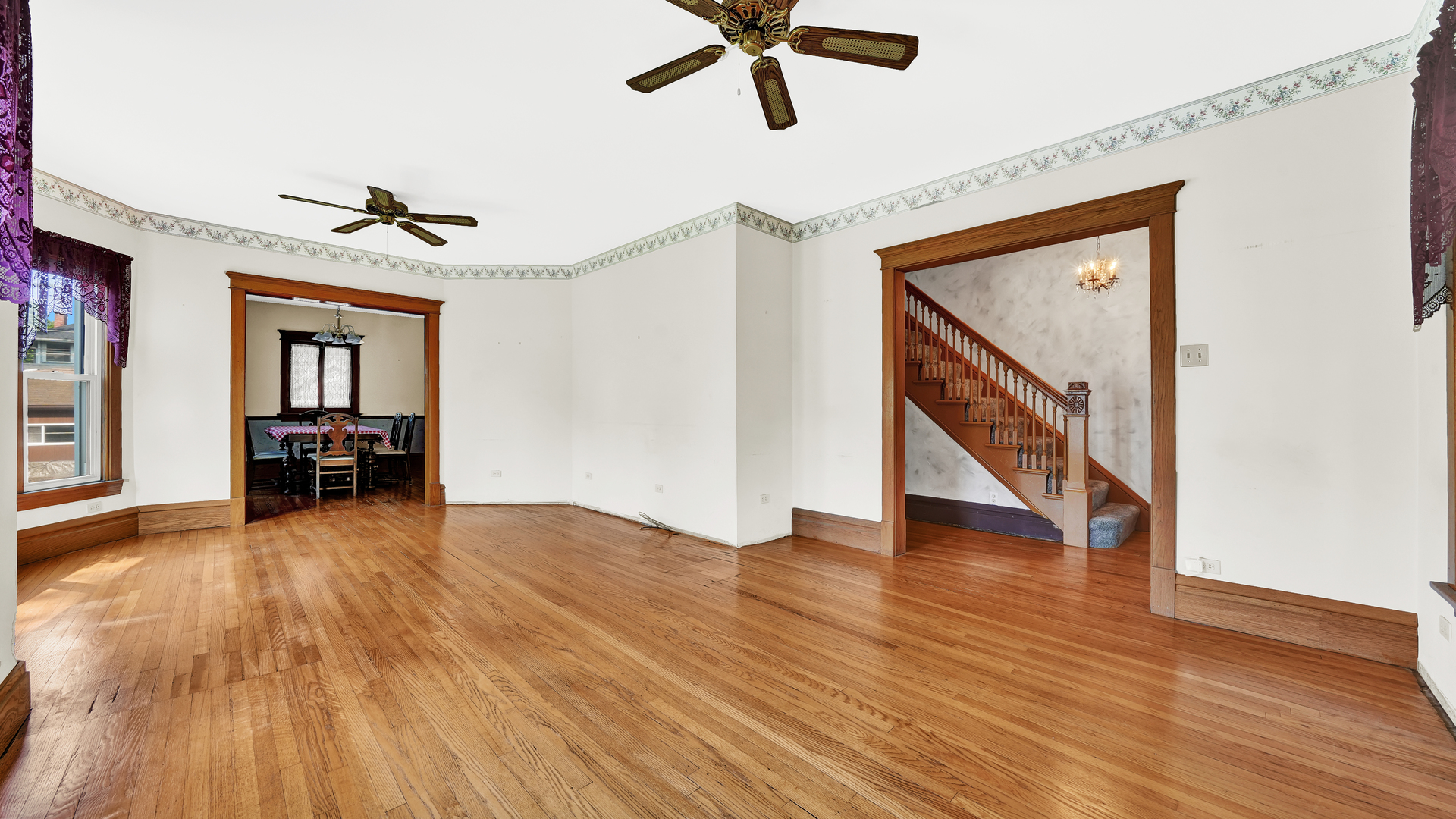 3130 Clinton Avenue Berwyn, IL 60402 - Photo 5 of 30 a view of an empty room with wooden floor and a ceiling fan