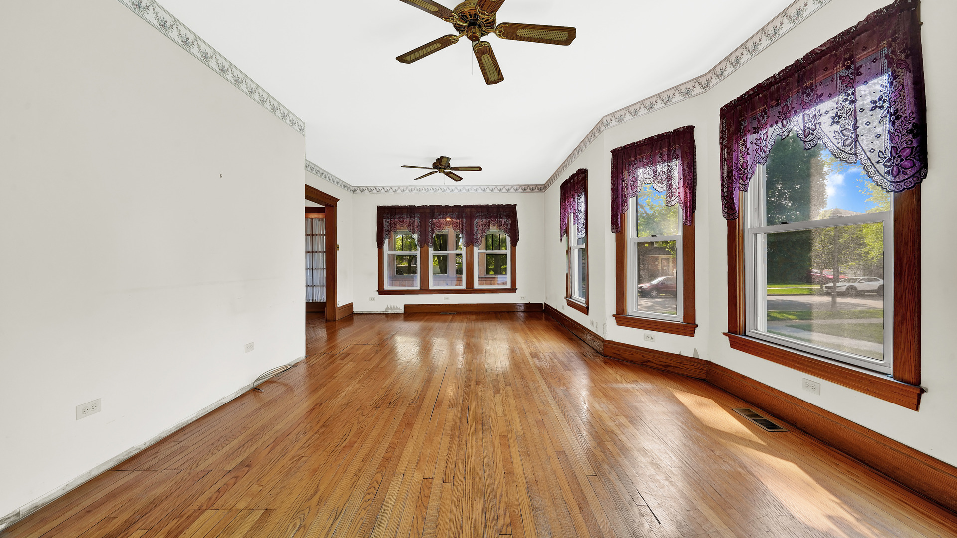 3130 Clinton Avenue Berwyn, IL 60402 - Photo 7 of 30 a view of an empty room with a window and wooden floor