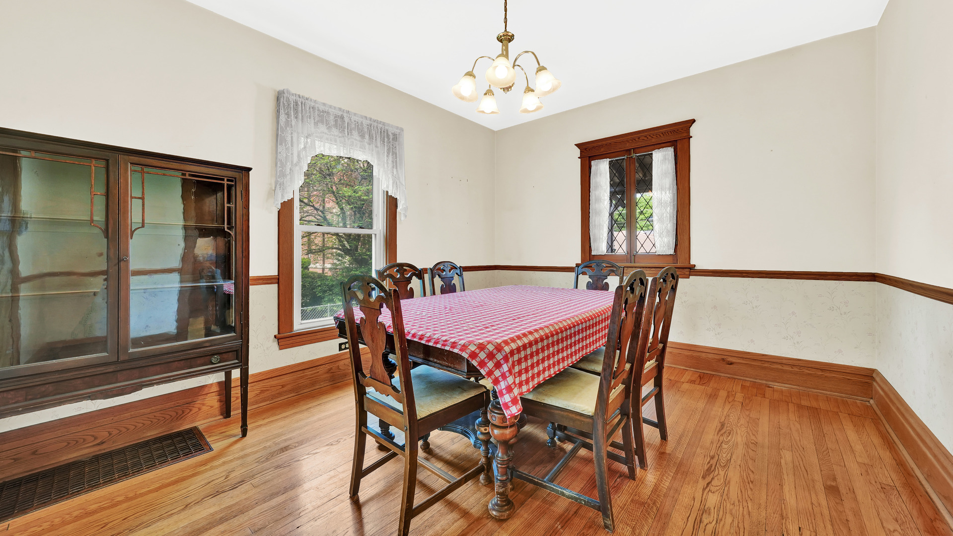 3130 Clinton Avenue Berwyn, IL 60402 - Photo 9 of 30 a view of a dining room with furniture wooden floor and a chandelier