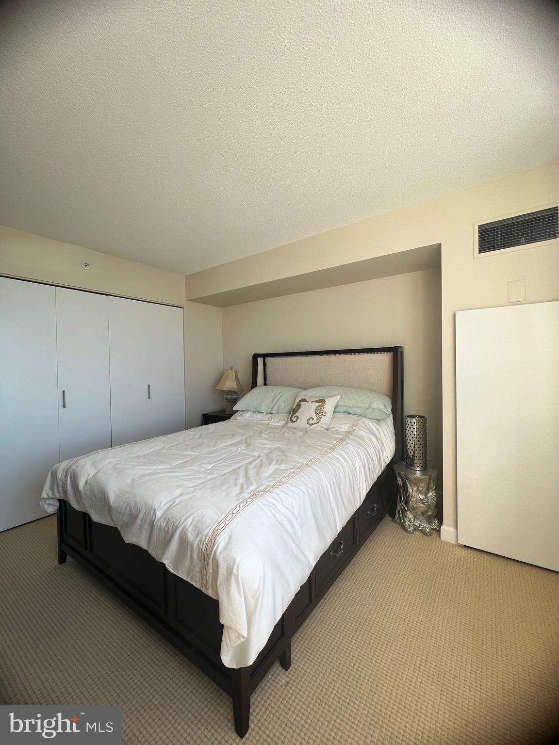 526 Pacific Avenue Atlantic City, NJ 08401 - Photo 11 of 21 a large bed sitting in a bedroom next to a cabinet