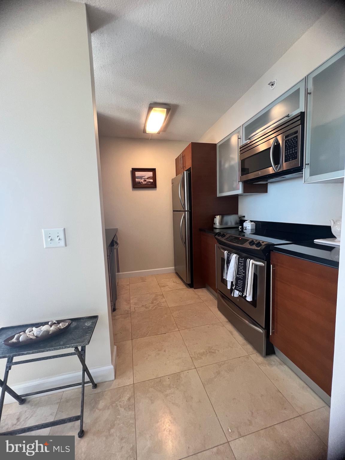 526 Pacific Avenue Atlantic City, NJ 08401 - Photo 13 of 21 a kitchen with stainless steel appliances a stove a microwave and a refrigerator