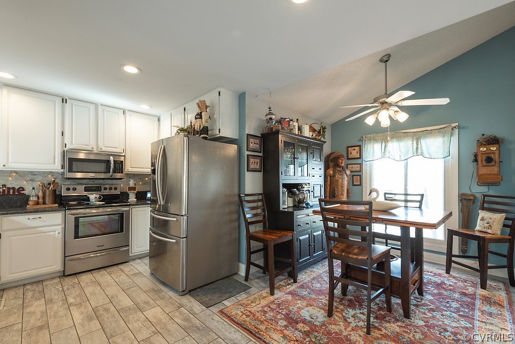 4708 Twin Cedars Road Chester, VA 23831 - Photo 12 of 38 a kitchen with stainless steel appliances granite countertop a stove refrigerator and chairs