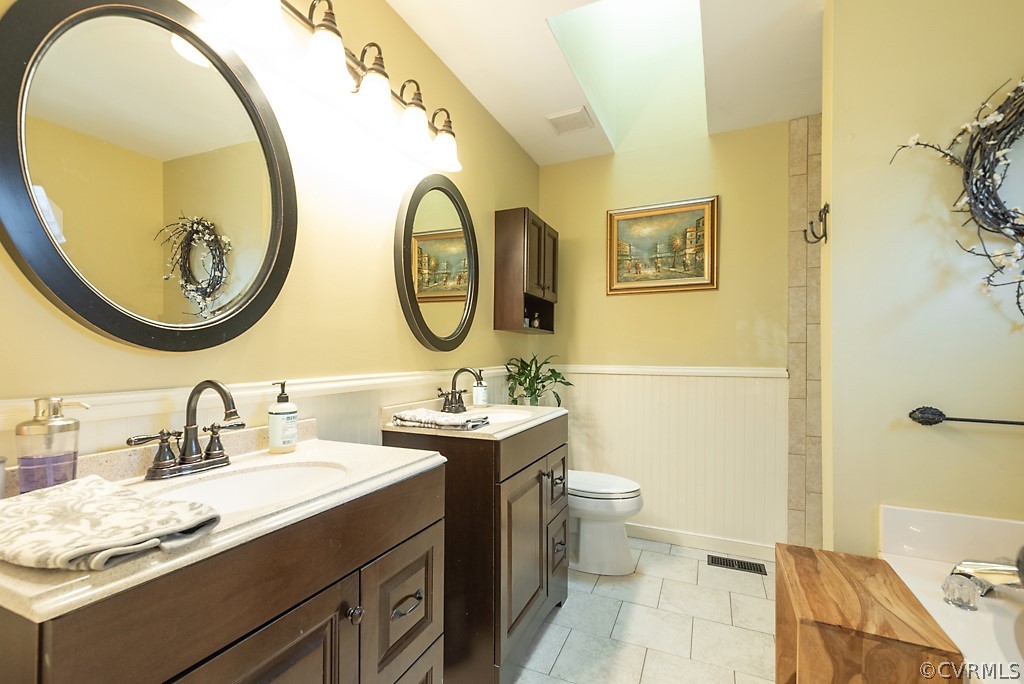 4708 Twin Cedars Road Chester, VA 23831 - Photo 22 of 38 a bathroom with a double vanity sink mirror and toilet