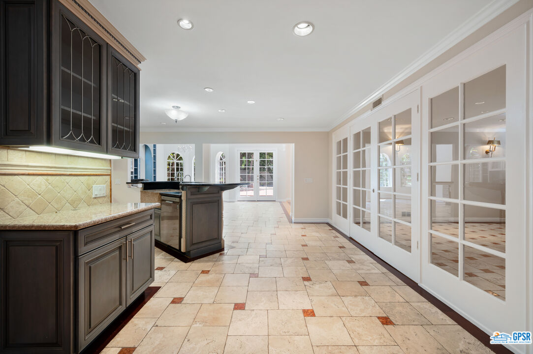3290 Malcolm Avenue Los Angeles, CA 90034 - Photo 12 of 58 a kitchen with stainless steel appliances granite countertop a stove a sink and a refrigerator