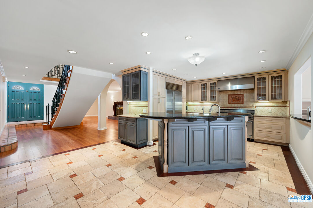3290 Malcolm Avenue Los Angeles, CA 90034 - Photo 14 of 58 a kitchen with stainless steel appliances granite countertop a stove refrigerator and cabinets