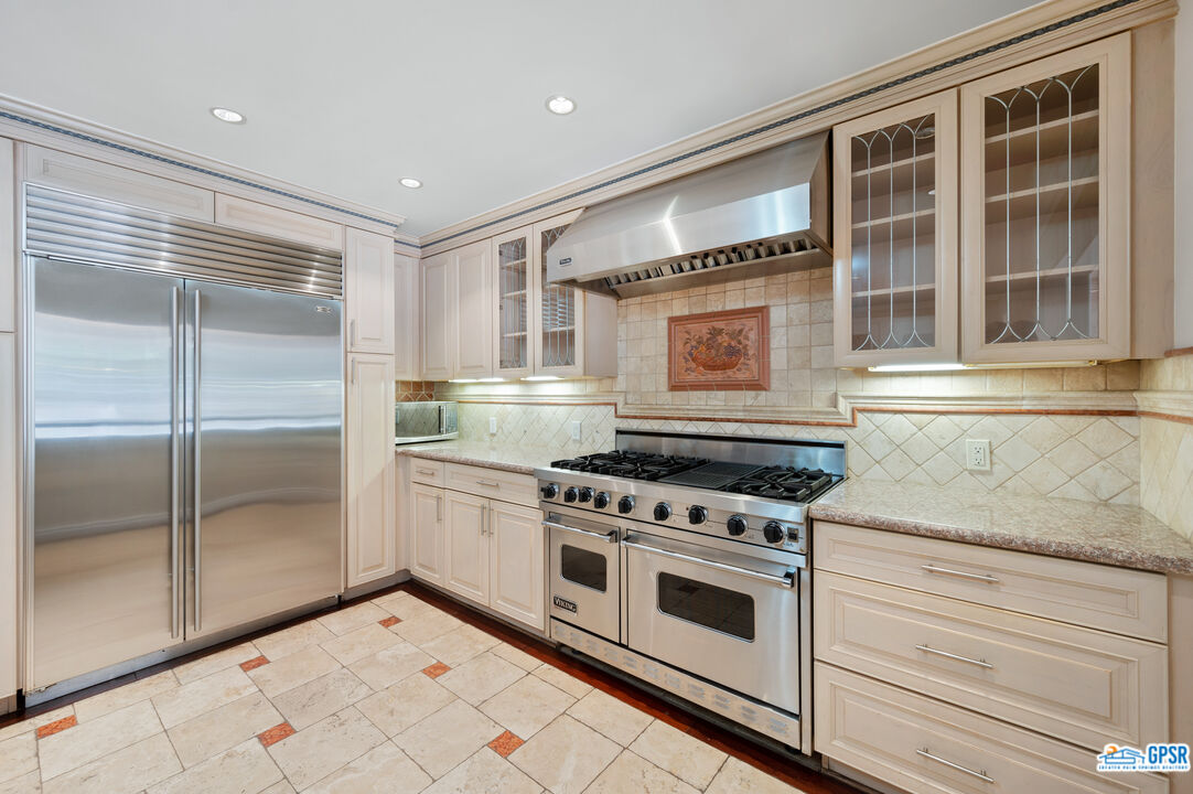 3290 Malcolm Avenue Los Angeles, CA 90034 - Photo 16 of 58 a kitchen with stainless steel appliances granite countertop a stove and a refrigerator