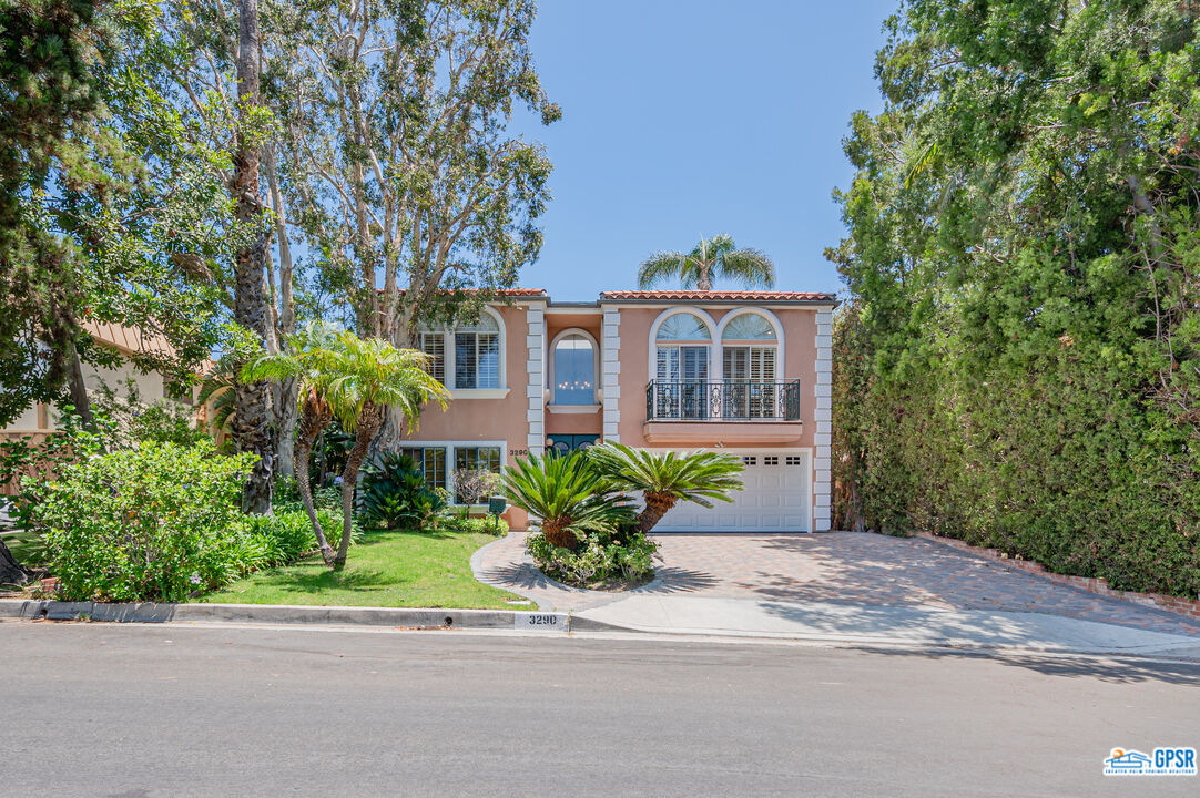 3290 Malcolm Avenue Los Angeles, CA 90034 - Photo 2 of 58 a front view of a house with a porch and a yard