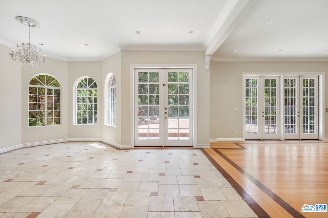 3290 Malcolm Avenue Los Angeles, CA 90034 - Photo 21 of 58 a view of a room with large windows and chandelier