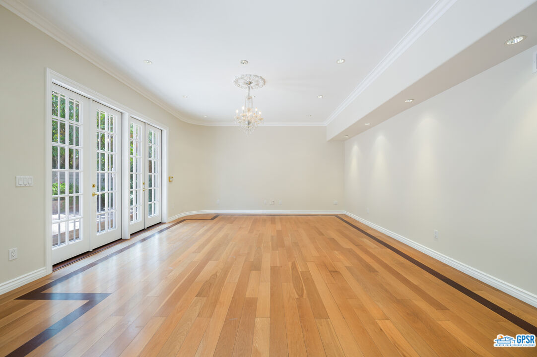 3290 Malcolm Avenue Los Angeles, CA 90034 - Photo 24 of 58 a view of an empty room with wooden floor and a window