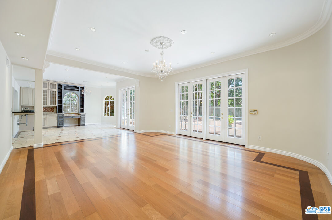 3290 Malcolm Avenue Los Angeles, CA 90034 - Photo 25 of 58 a view of an empty room with wooden floor and a window
