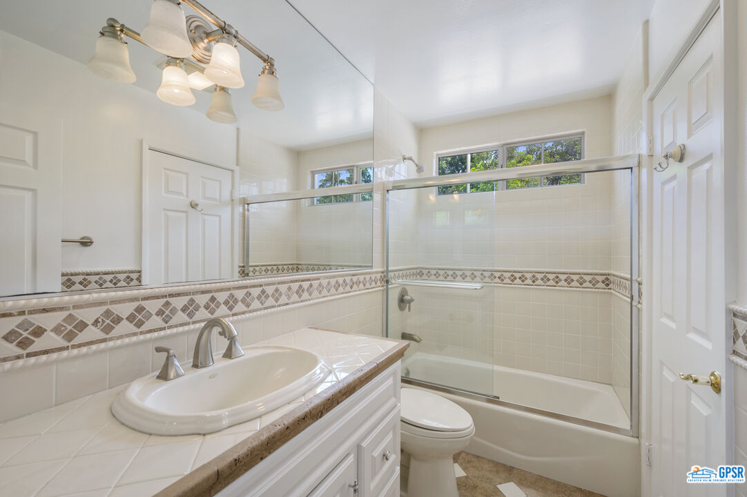 3290 Malcolm Avenue Los Angeles, CA 90034 - Photo 30 of 58 a bathroom with a sink a toilet and shower