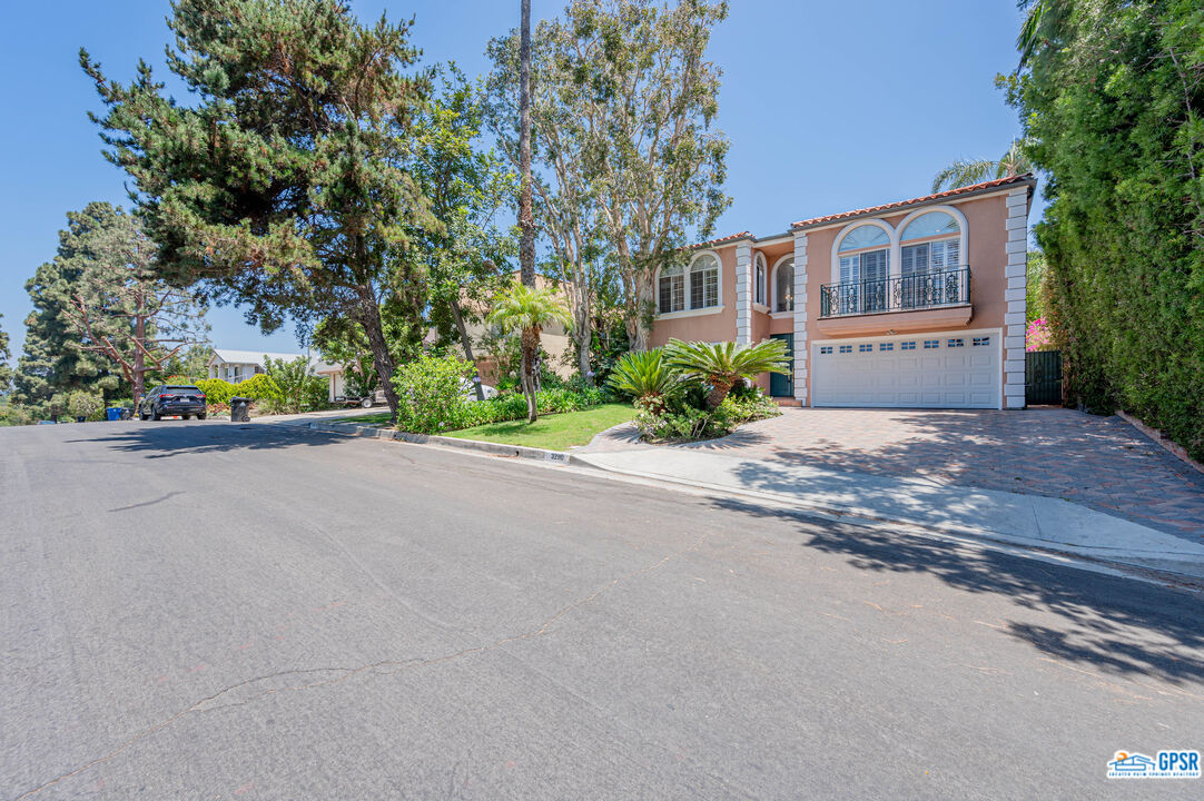 3290 Malcolm Avenue Los Angeles, CA 90034 - Photo 3 of 58 a view of a street with a house