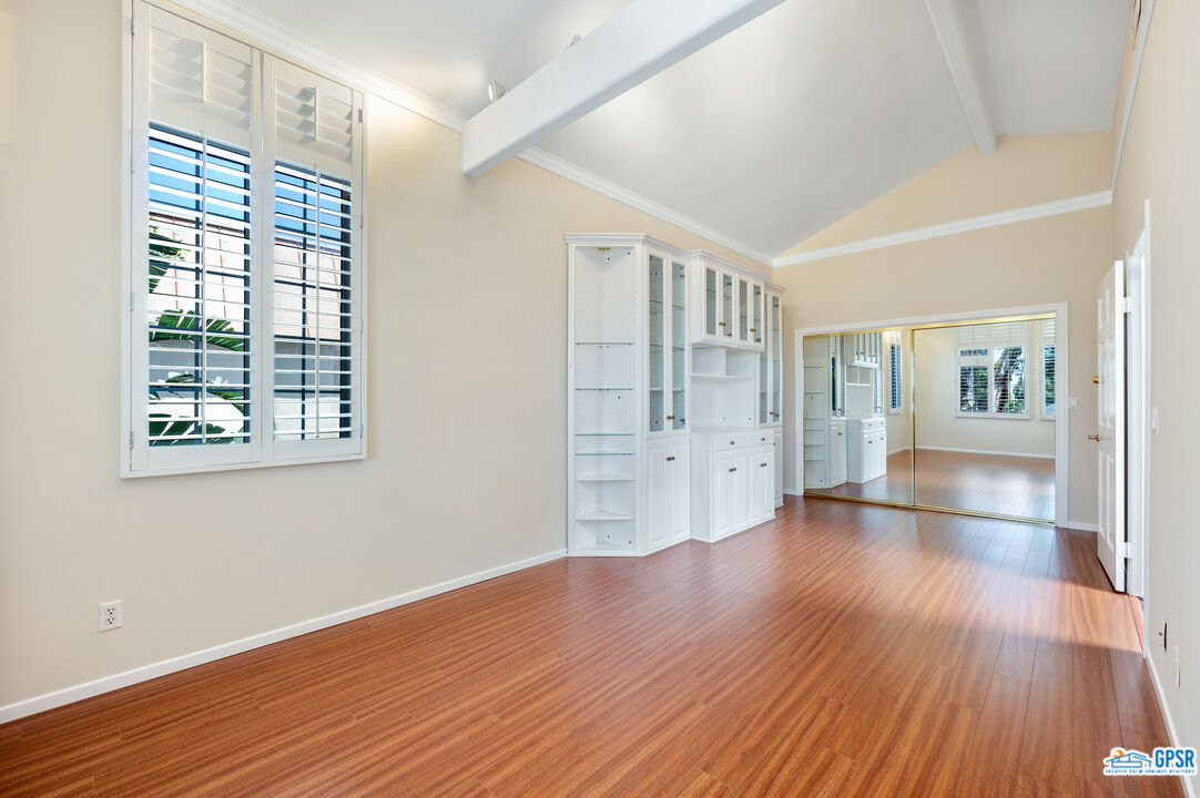 3290 Malcolm Avenue Los Angeles, CA 90034 - Photo 34 of 58 an empty room with wooden floor and windows