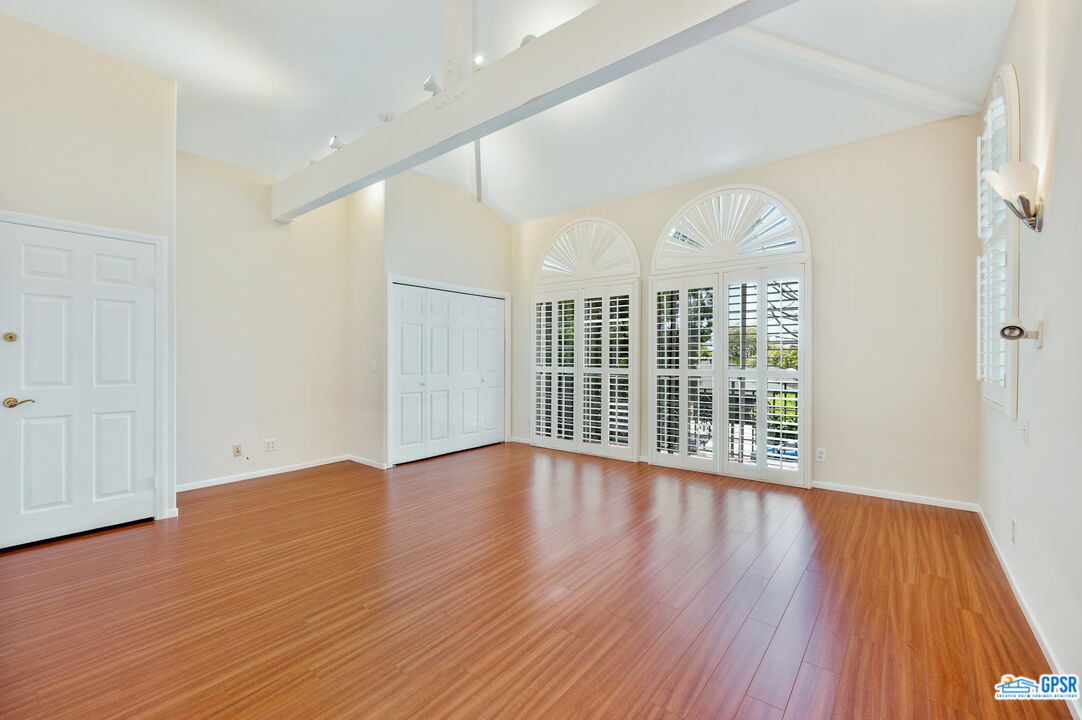 3290 Malcolm Avenue Los Angeles, CA 90034 - Photo 35 of 58 a view of an empty room with wooden floor and a window