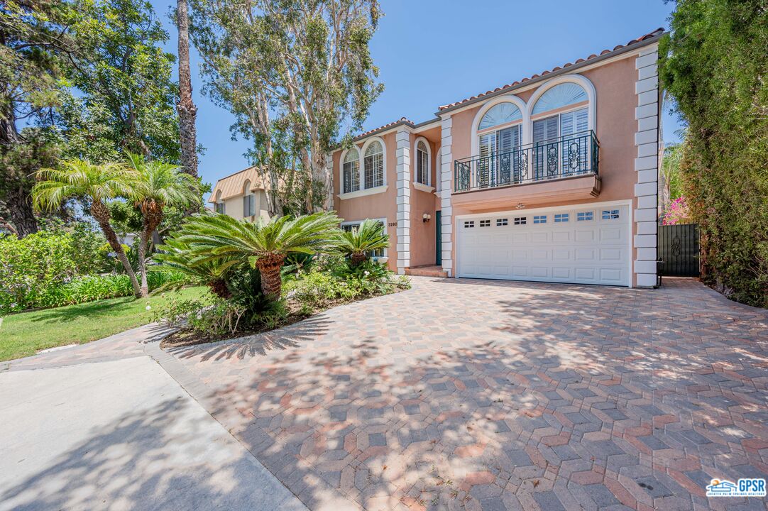3290 Malcolm Avenue Los Angeles, CA 90034 - Photo 4 of 58 a front view of a house with a yard and a garage