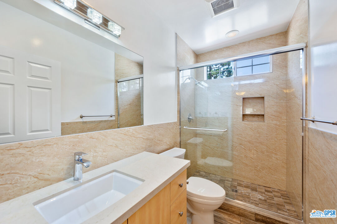3290 Malcolm Avenue Los Angeles, CA 90034 - Photo 43 of 58 a bathroom with a sink a toilet and shower