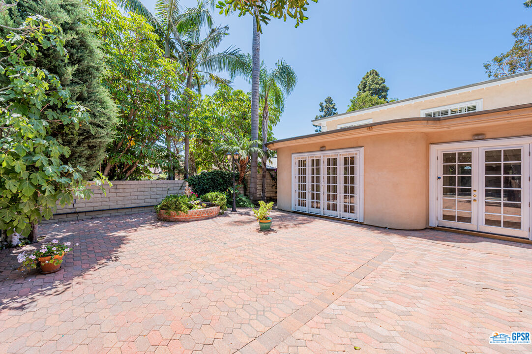 3290 Malcolm Avenue Los Angeles, CA 90034 - Photo 51 of 58 a view of a patio with table and chairs and potted plants