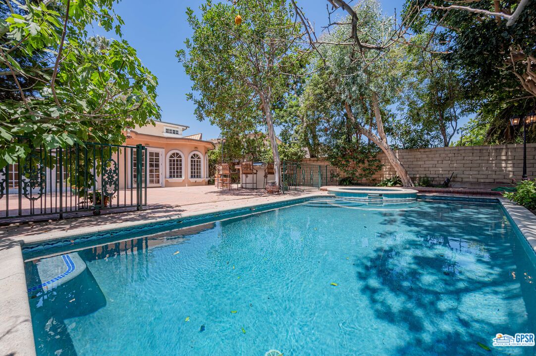 3290 Malcolm Avenue Los Angeles, CA 90034 - Photo 55 of 58 a view of a house with swimming pool next to a yard
