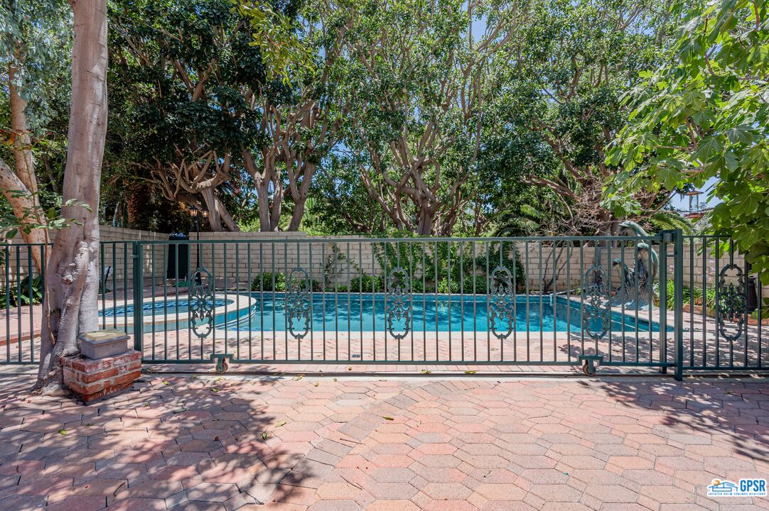 3290 Malcolm Avenue Los Angeles, CA 90034 - Photo 58 of 58 a view of a fence with trees in the background
